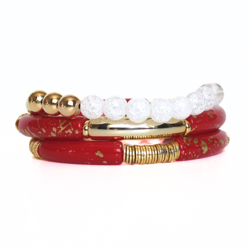 This 3-piece red beaded stretch bracelet set is the perfect statement piece. With its bold and bright colors, this bracelet set is designed with 18K gold filled beads, white crackled beads, and red and gold acrylic bangles.