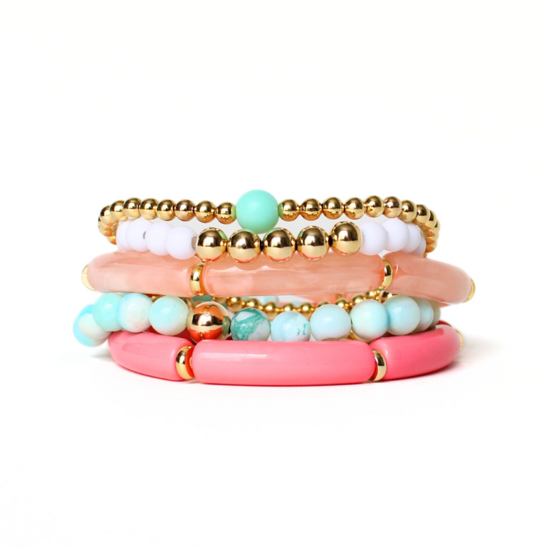 5-peice beach inspired stack. Designed with blue opal gemstone beads with gold filled round beads. Two acrylic 8mm skinny tube bangles with gold plated flats. Acrylic tubes are peach marble and watermelon. The other two bracelets in this set are dainty and are adorned with gold filled round beads. 6mm blue acrylic beads and 5mm white acrylic beads accent the gold bracelets.