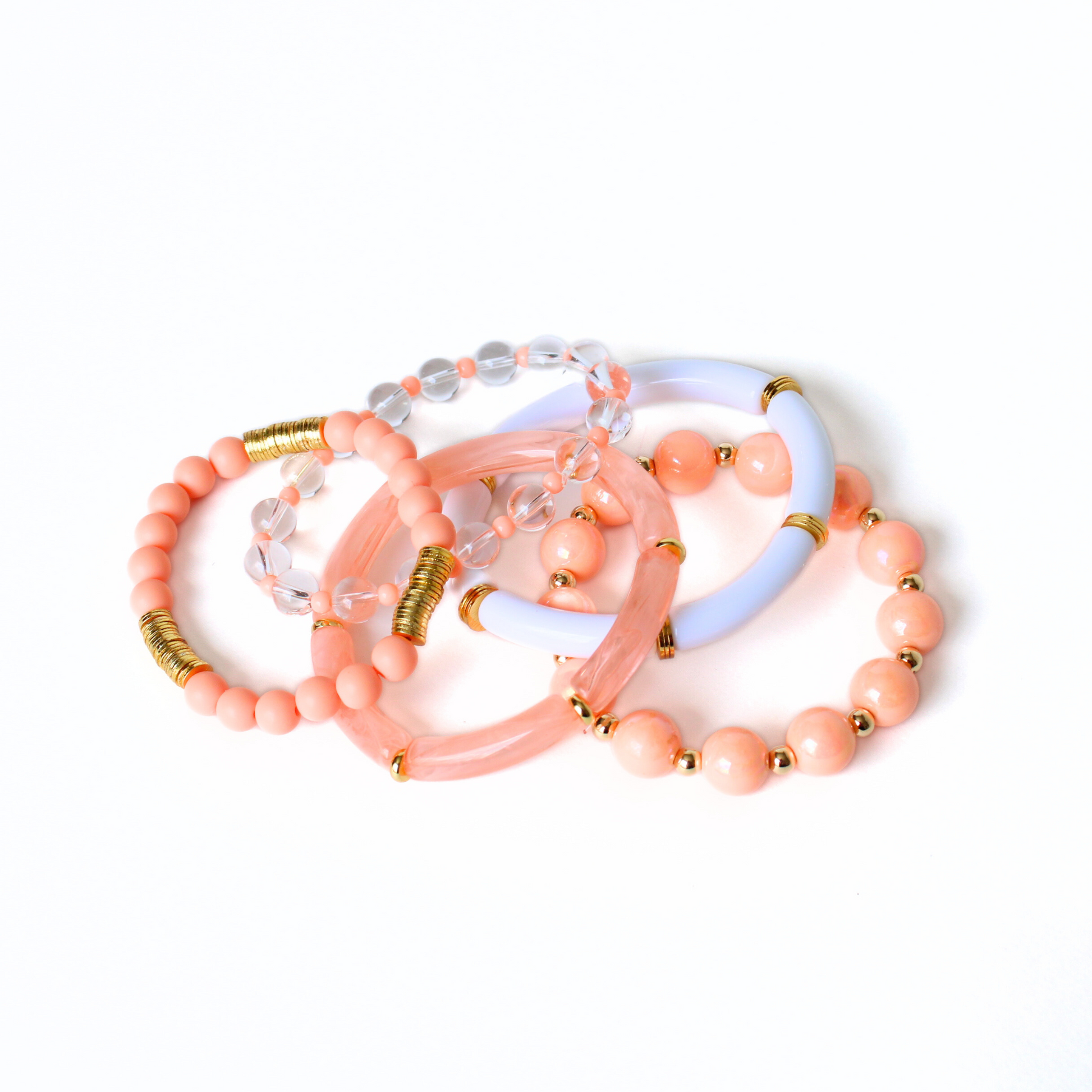 5-peice peach golden hour bracelet stack. This bracelet stack has two 8mm skinny bamboo acrylic tube bangles; peach marble and white. Clear 6mm quartz round beads with alternating 4mm peach acrylic beads. 12mm chunky acrylic round beads with alternating gold filled round beads. And also designed with 6mm peach acrylic round beads with gold plated flats.