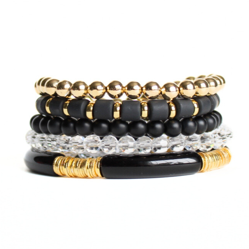 5-piece black beaded stretch bracelet set. is designed with 18k gold-filled beads. Also designed with black polymer clay beads, clear and black glass beads and black acrylic bangles. This stack is perfect for that night out with the girls or that special someone. Dress up any dress or pant suit with this classic black statement piece.