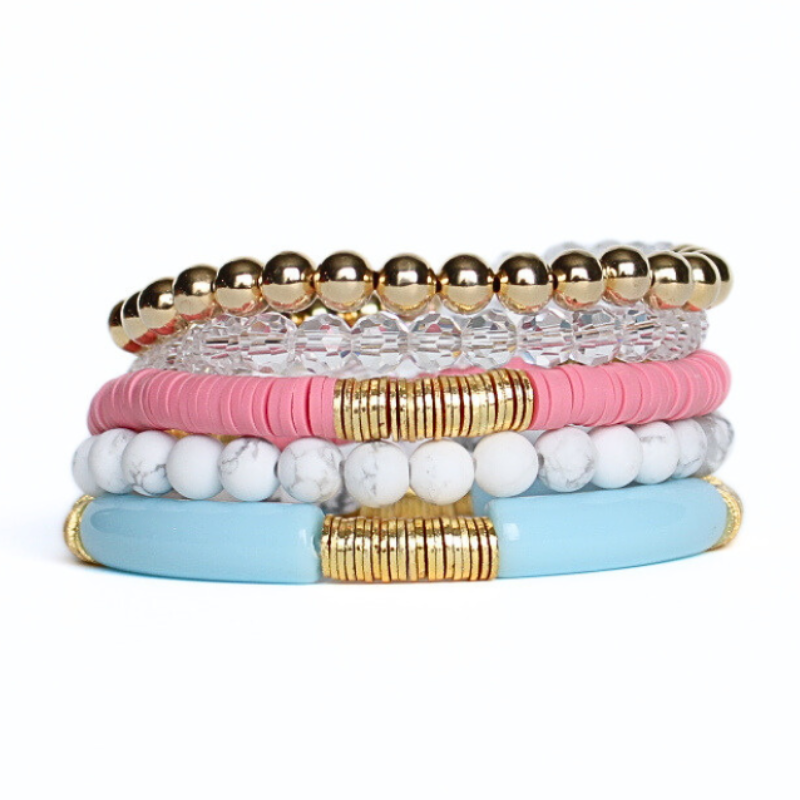 5-Piece 18K gold beaded stretch bracelet set with white howlite gemstones and pink polymer clay beads. Blue acrylic bangle with gold beads.