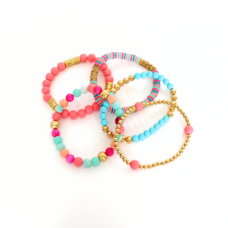 Bracelet stack with 5 beaded stretch bracelets. The Key West bracelet stack is designed with blue and watermelon acrylic beads and polymer clay beads. This bracelet stack is adorned with pink and blue opal gemstones. 18K gold filled beads add long lasting sparkle to this stack.