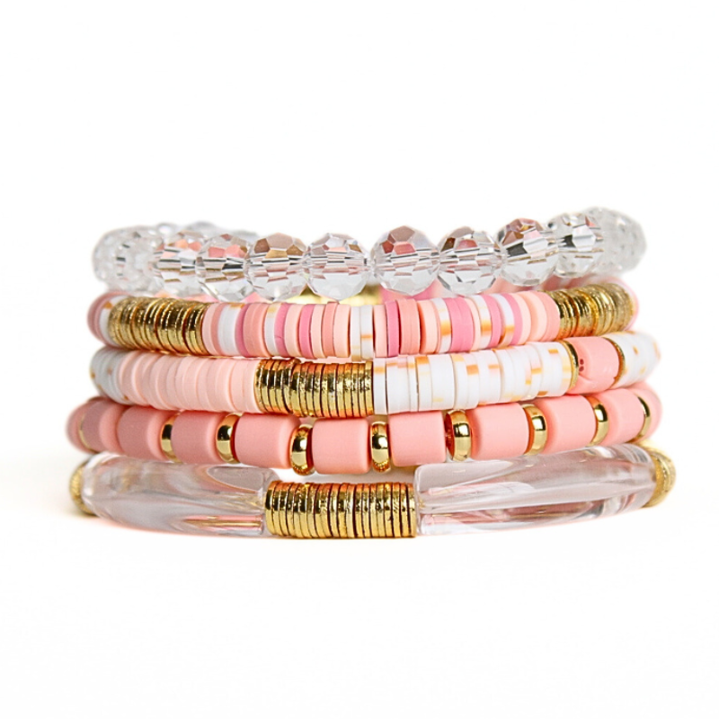 5-piece gold beaded bracelet styled with peach polymer beaded bracelets and clear glass beads