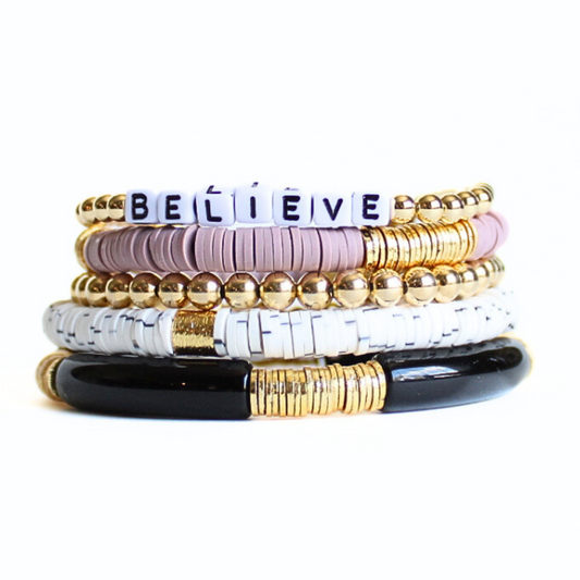Purple and black 5-piece stretch bracelet set with 18k gold filled beads, polymer clay beads and black acrylic curved tube beads. White cubed acrylic letter beads that are personalizable