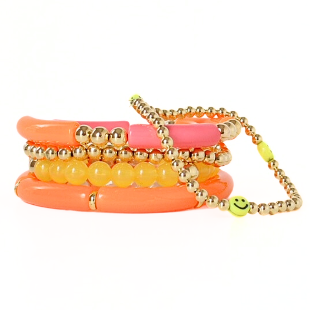 5-piece vibrant peach and yellow acrylic bracelet stack with 18k gold filled round beads. This set has a dainty gold beaded bracelet with cute yellow smiley face beads