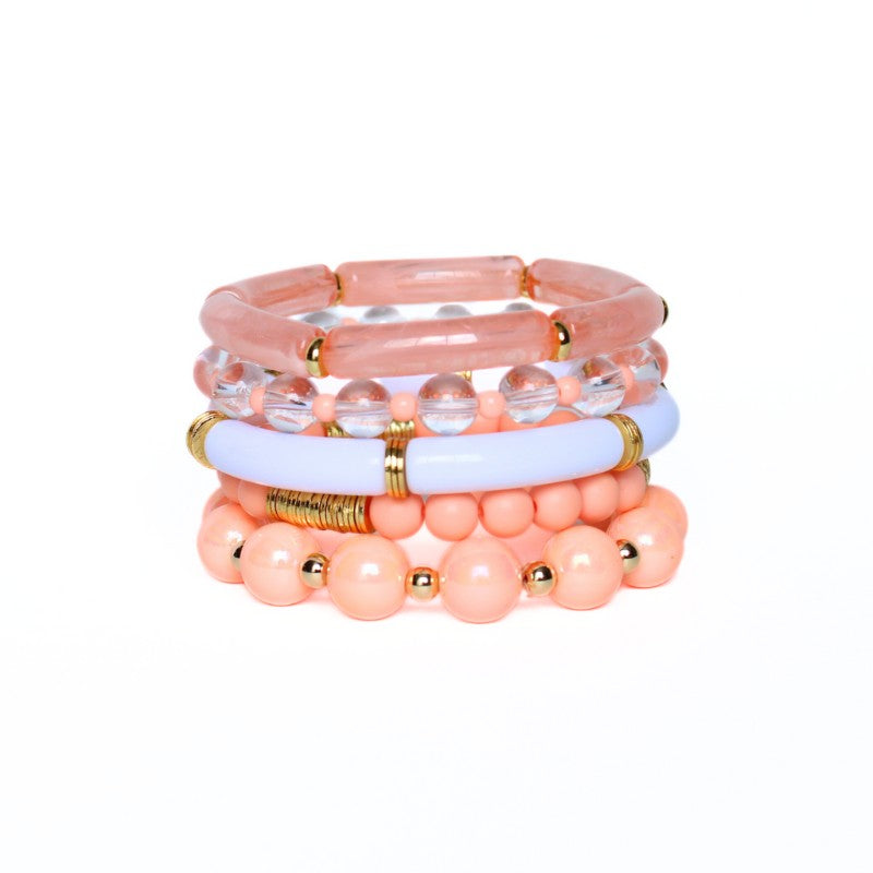 5-peice peach golden hour bracelet stack. This bracelet stack has two 8mm skinny bamboo acrylic tube bangles; peach marble and white. Clear 6mm quartz round beads with alternating 4mm peach acrylic beads. 12mm chunky acrylic round beads with alternating gold filled round beads. And also designed with 6mm peach acrylic round beads with gold plated flats.