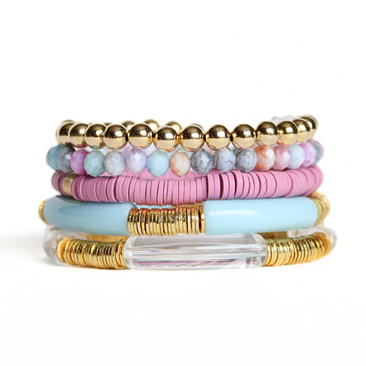 This 5-piece blue and purple beaded stretch bracelet set is the perfect statement piece. With its bold and bright colors, it is designed with 18K gold filled beads, clear round natural Brazilian beads and blue matte jade beads. The pink acrylic bangle and the pink and blue rainbow polymer clay beads add that pop of color.