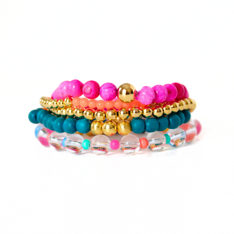 5-piece pink and green beaded bracelet stack. This bracelet stack is designed with pink opal beads, gold-filled bead, clear quartz beads and light weight blue beads