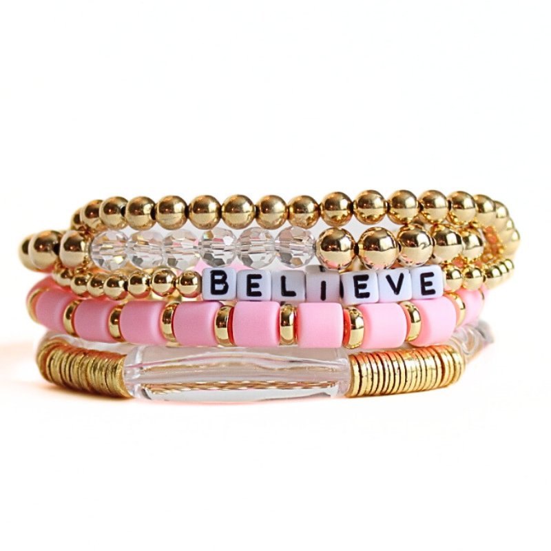 5-piece pink polymer clay bracelet, gold-filled beaded bracelets and clear acrylic bangle bracelet with gold flat spacers. This bracelet has a customizable letter bead bracelet.