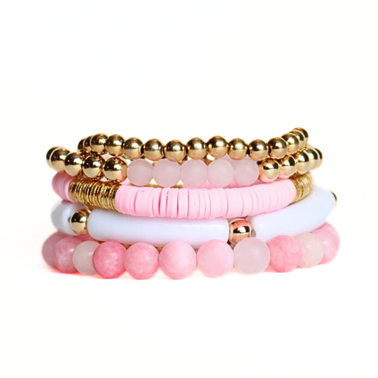 This 5-piece pink beaded stretch bracelet set is the perfect statement piece. With its bold and bright colors, it is designed with 18K gold filled beads and rose quarts matte beads. The white acrylic bangle and the pink polymer clay beads add that pop of color.