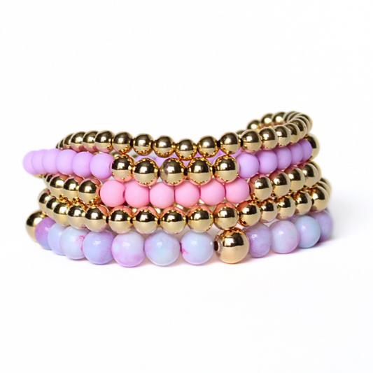 5-piece purple and pink feminine stack. Adorned with 6mm purple opal gemstone beads, pink and purple acrylic beads with 18k gold filled round beads.