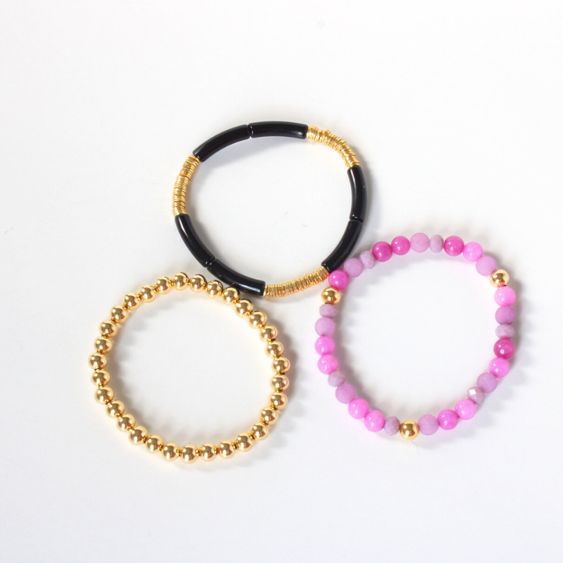 3-piece pink and black stretch bracelet stack. Designed with a skinny black acrylic tube bangle, pink and purple semi-precious beaded bracelet and a gold-filled beaded bracelet.