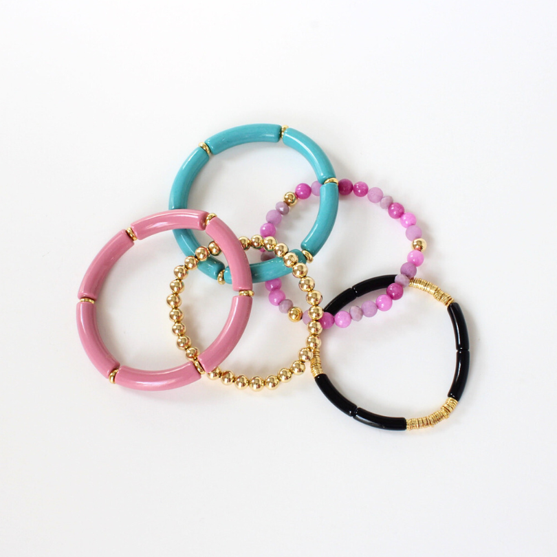 5-piece bracelet stack designed with blue and rose acrylic tubes and a skinny black acrylic tube bangle. This beautiful bracelet stack has purple and pink semi-precious beaded bracelet. A 6mm gold-filled beaded bracelet adds the perfect amount glam.