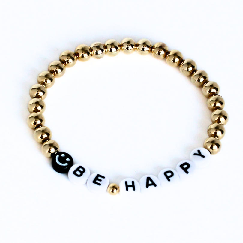 Gold beaded word bracelet with smiley face bead