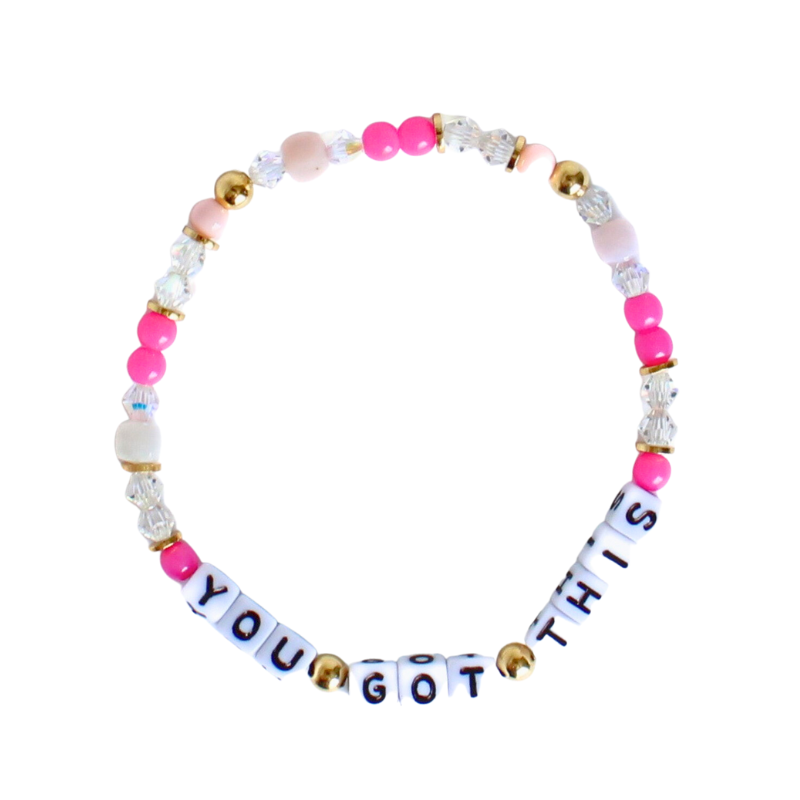 Breast cancer awareness bracelet with customizable cubed letter beads and pink dainty beads.