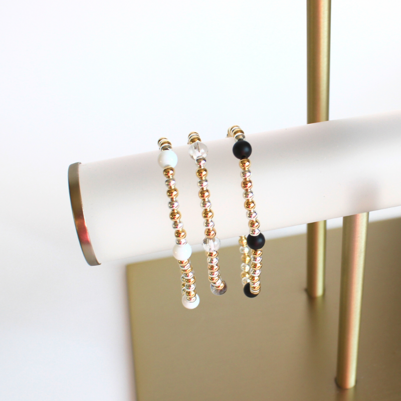 This delicate two-toned beaded bracelet is the perfect bracelet for everyday wear. With both gold filled and sterling silver tones, this bracelet can be worn with all of your bracelets. Also curated with black onyx gemstone beads.