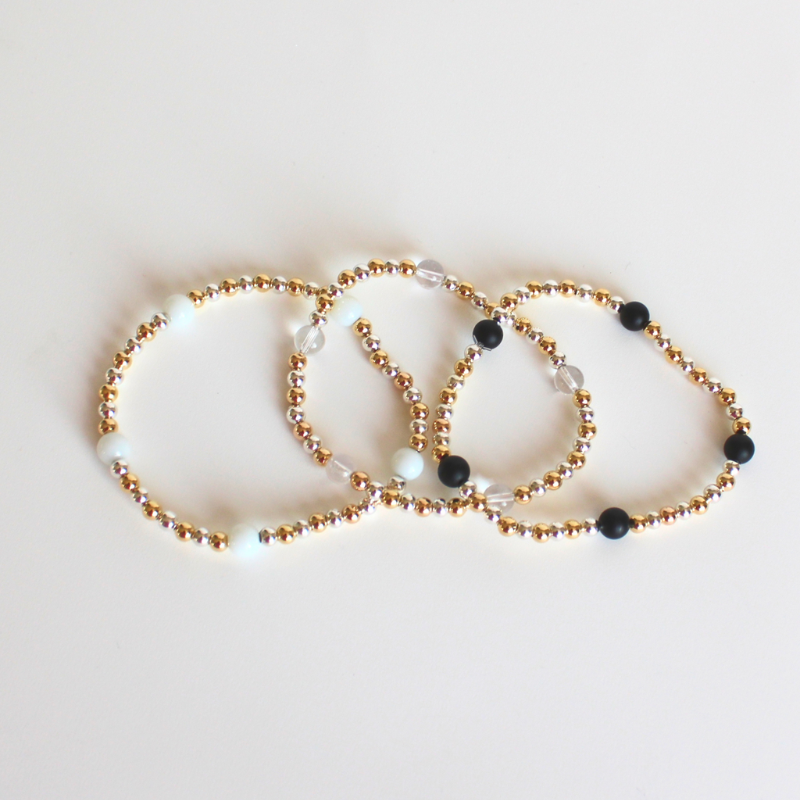 This delicate two-toned beaded bracelet is the perfect bracelet for everyday wear. With both gold filled and sterling silver tones, this bracelet can be worn with all of your bracelets. Also curated with white onyx gemstone beads.