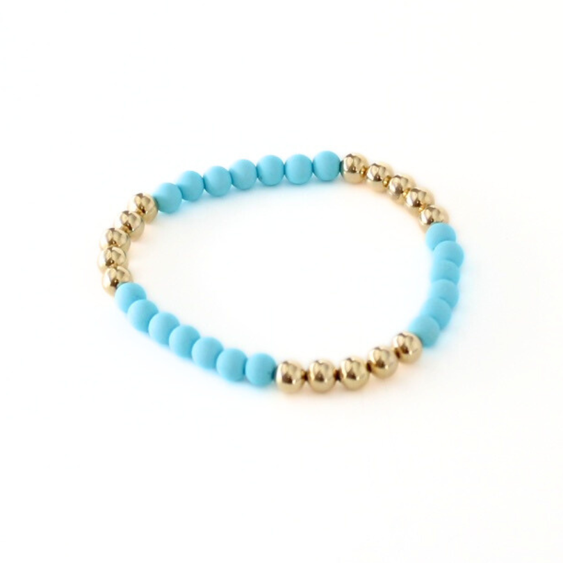 Single blue acrylic and gold beaded stretch bracelet