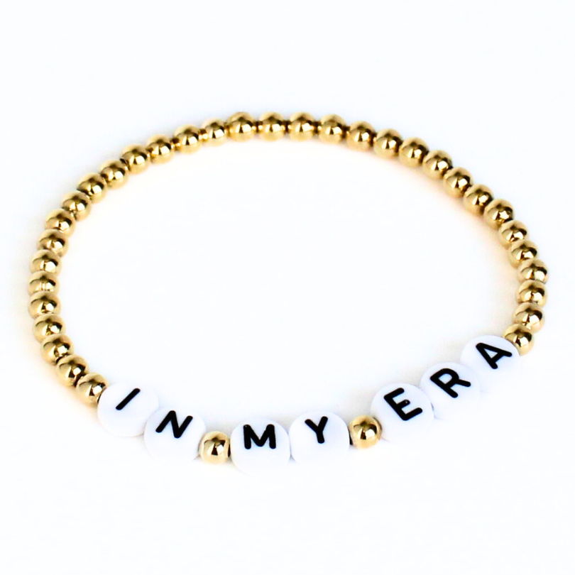 Gold Taylor Swift friendship bracelet with song lyrics