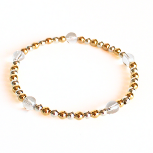This delicate two-toned beaded bracelet is the perfect bracelet for everyday wear. With both gold filled and sterling silver tones, this bracelet can be worn with all of your bracelets. Also styled with clear quartz gemstone beads.