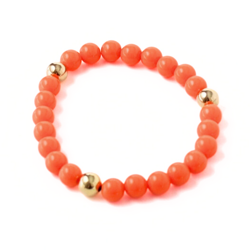 Bright orange acrylic beaded stretch bracelet. Accented with 18K gold filled round beads.