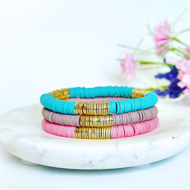 Single beaded bright and bold stretch bracelet for layering and stacking. Curated with blue polymer clay beads and gold-plated flat beads, this playful bracelet will add a pop of color to any outfit or bracelet stack. Wear alone or add to any bracelet to create the perfect look.