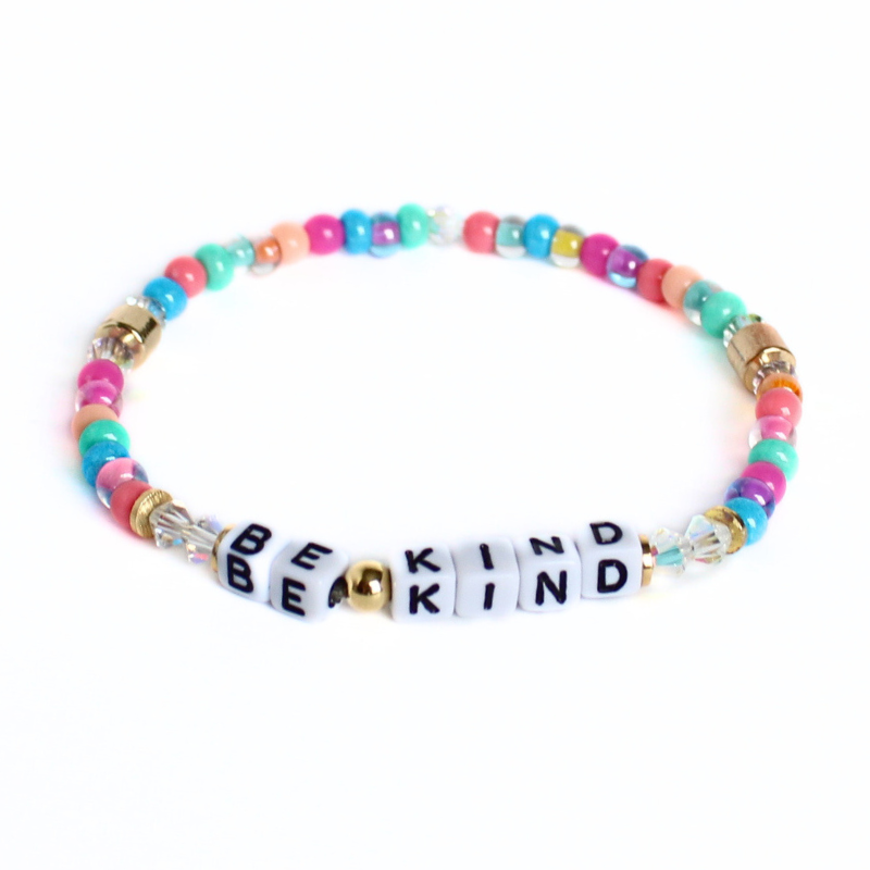 Dainty rainbow word stretch bracelet. White with black letter cubed acrylic letter bead that can be personalized. Designed with blue, orange, pink, green and clear 4mm seed beads.