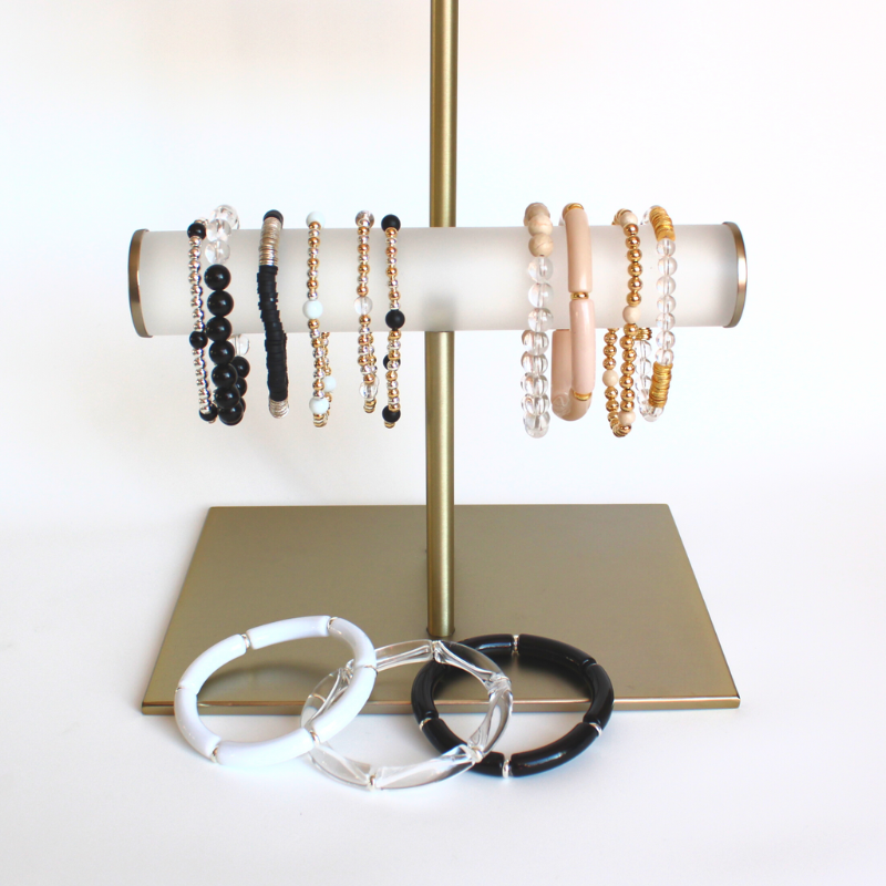 Jewelry stand holding silver and gold neutral Elliot Lane beaded bracelets