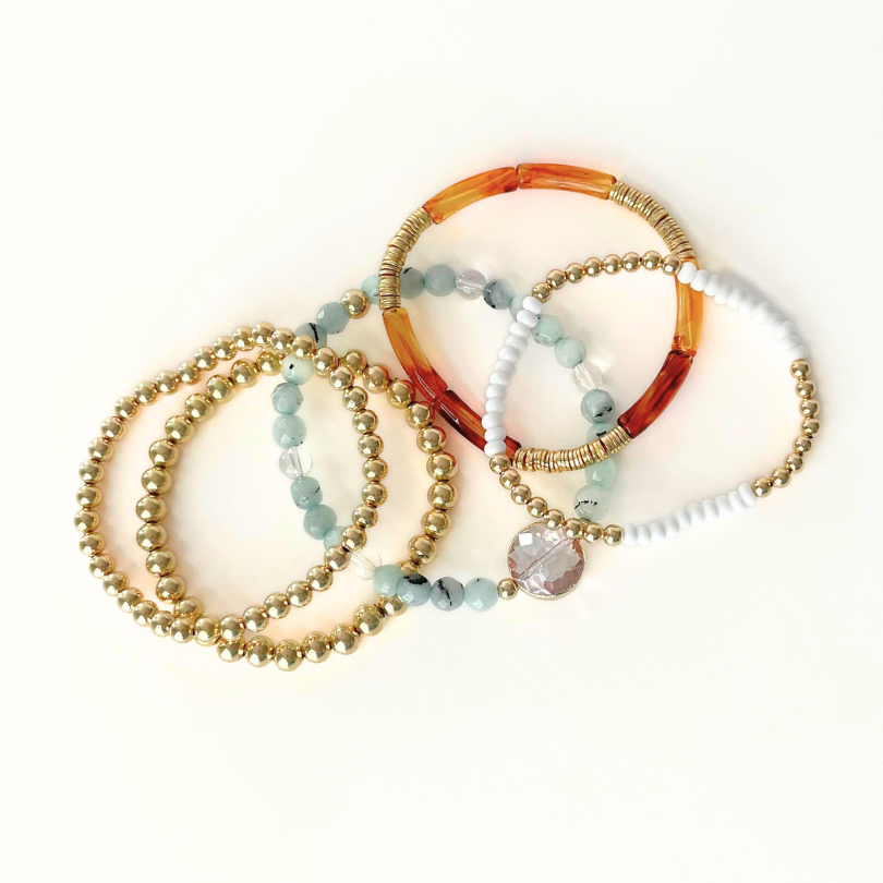 5-piece gold and acrylic beaded bracelets stack. With warm tones and easy to wear stretch style bracelets