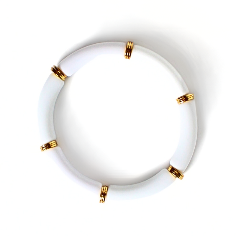 White 8mm skinny acrylic bamboo tubed bangle. Bracelet is accented with gold plated flats alternating after each acrylic tube.